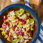 Italian chopped salad recipe made with just 4 ingredients served in a wooden salad bowl with blue rim
