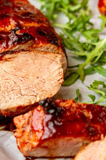 sliced grilled pork tenderloin with fresh arugula