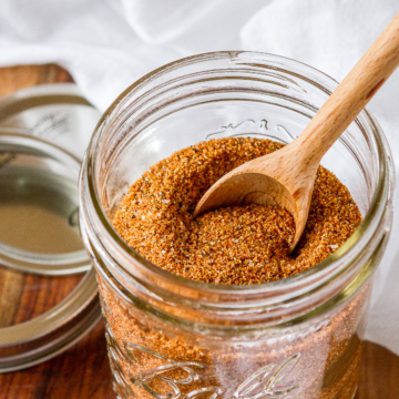 pork rub recipe in a mason jar with a wooden measuring spoon
