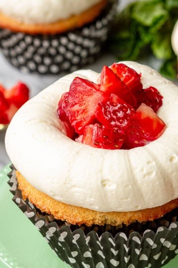 strawberry shortcake cupcakes with black and white polka dotted cupcake liners