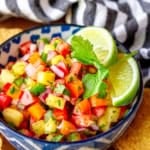 fresh pineapple jalapeno salsa recipe in a blue and white bowl with tortilla chips