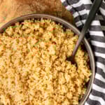 instant pot brown rice recipe in a gray bowl with a black serving spoon