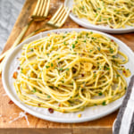 olive oil pasta recipe on a white plate with a gold fork