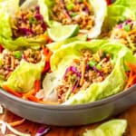 pork lettuce wraps recipe made with ground pork and bibb lettuce in a gray ceramic bowl