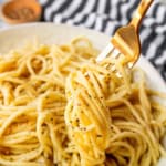 best cacio e pepe recipe twirled around a gold fork