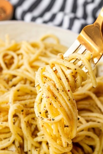 best cacio e pepe recipe twirled around a gold fork