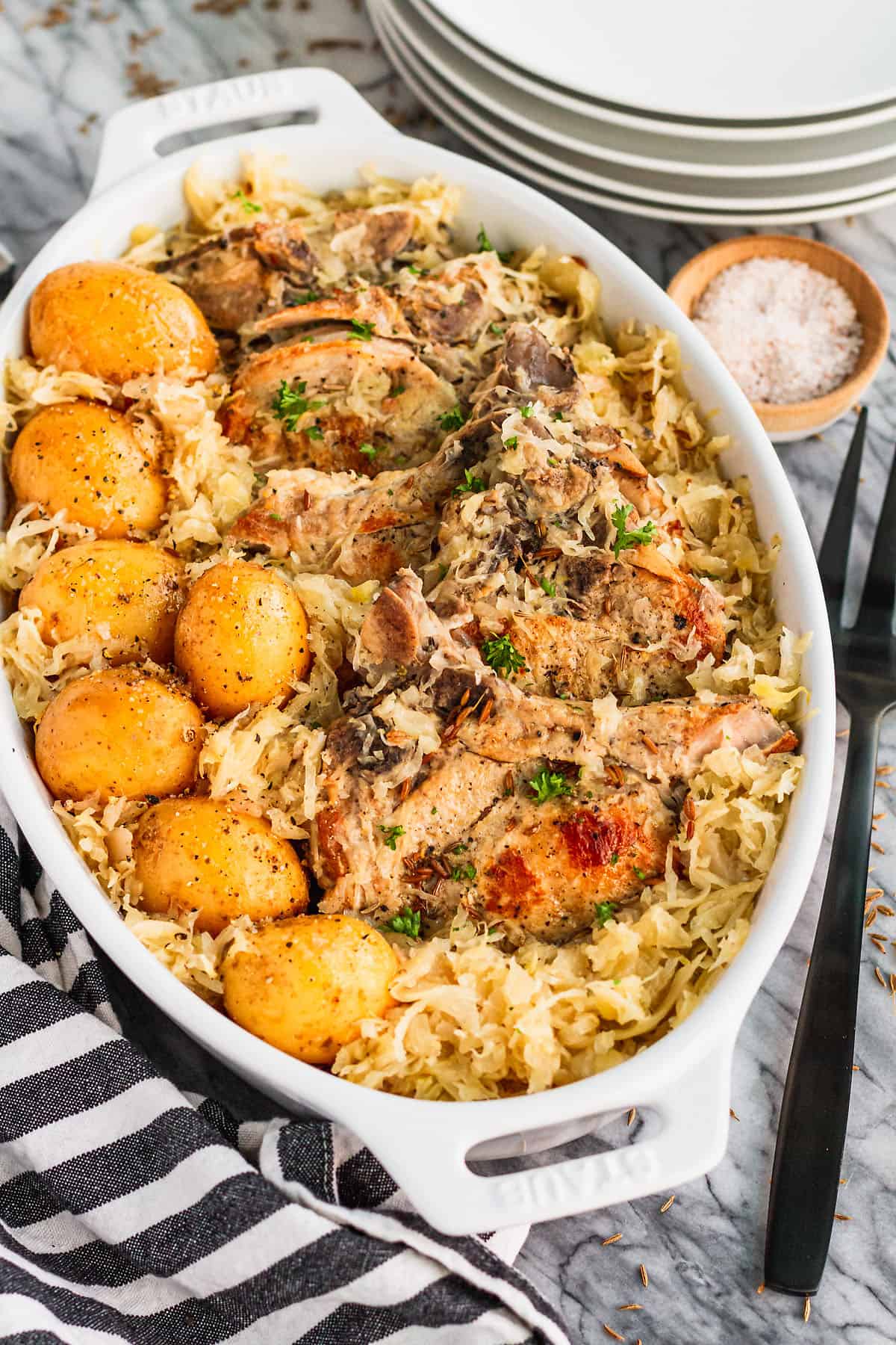 bone-in pork chops and sauerkraut plus baby yellow potatoes made in the slow cooker ready to serve