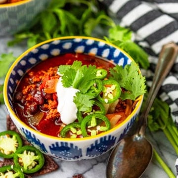instant pot turkey chili in a blue and white ceramic bowl with a yellow rim