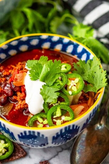 instant pot turkey chili in a blue and white ceramic bowl with a yellow rim