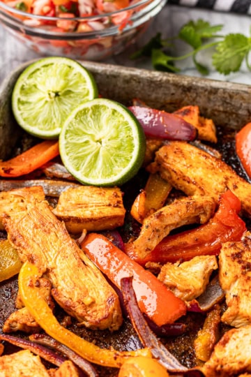 sheet pan chicken fajitas recipe with limes and pico de gallo