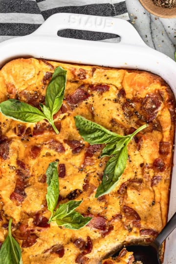 breakfast casserole with bacon recipe in a white ceramic baking dish