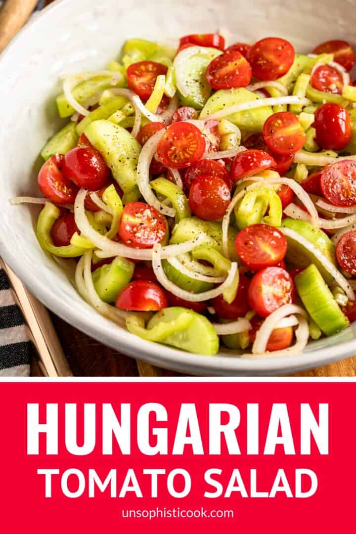 hungarian tomato salad with wax peppers, cucumbers, and onions in a white ceramic bowl pinterest graphic
