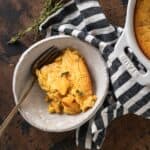 jiffy corn casserole recipe in a ceramic bowl with a fork