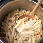 instant pot recipes cream cheese pasta sauce being scooped out with a wooden serving spoon