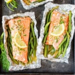two salmon grilled in foil with green beans and fresh dill