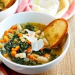 ceramic bowl of tuscan bean soup with kale