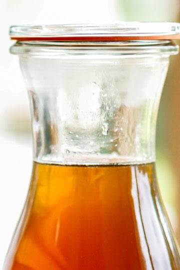 rich simple syrup in a glass bottle with a lid
