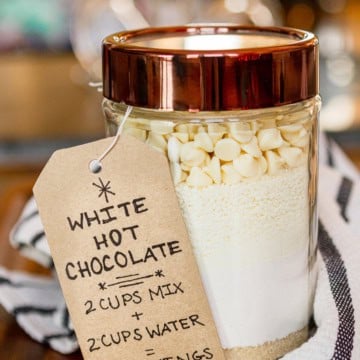 white hot chocolate mix in a glass jar with a copper colored lid