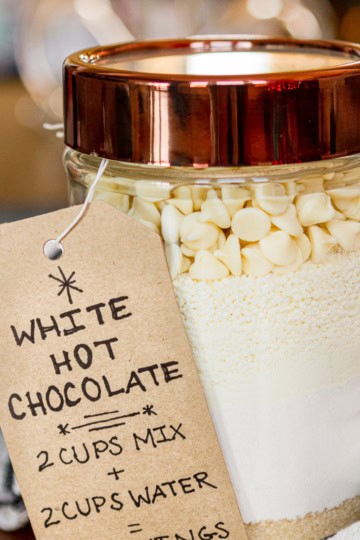 white hot chocolate mix in a glass jar with a copper colored lid