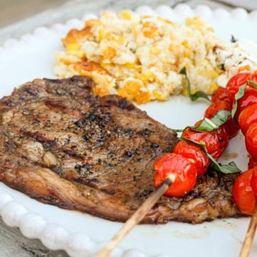 rib eye steak marinated in a coffee ribeye steak marinade with grilled cherry tomatoes and corn casserole