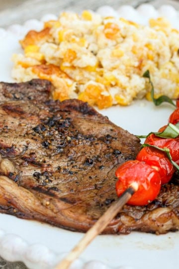 rib eye steak marinated in a coffee ribeye steak marinade with grilled cherry tomatoes and corn casserole