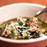 italian wedding soup in a bowl garnished with romano cheese