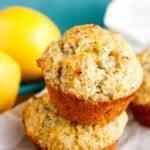 lemon poppy seed muffins stacked up with fresh lemons