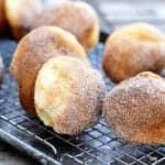 never fail popovers dusted with a cinnamon sugar mixture cooling on a wire rack