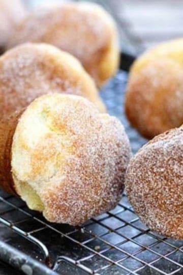 never fail popovers dusted with a cinnamon sugar mixture cooling on a wire rack