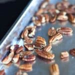 roasted nuts cooling on a baking sheet