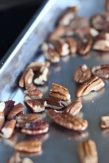 roasted nuts cooling on a baking sheet
