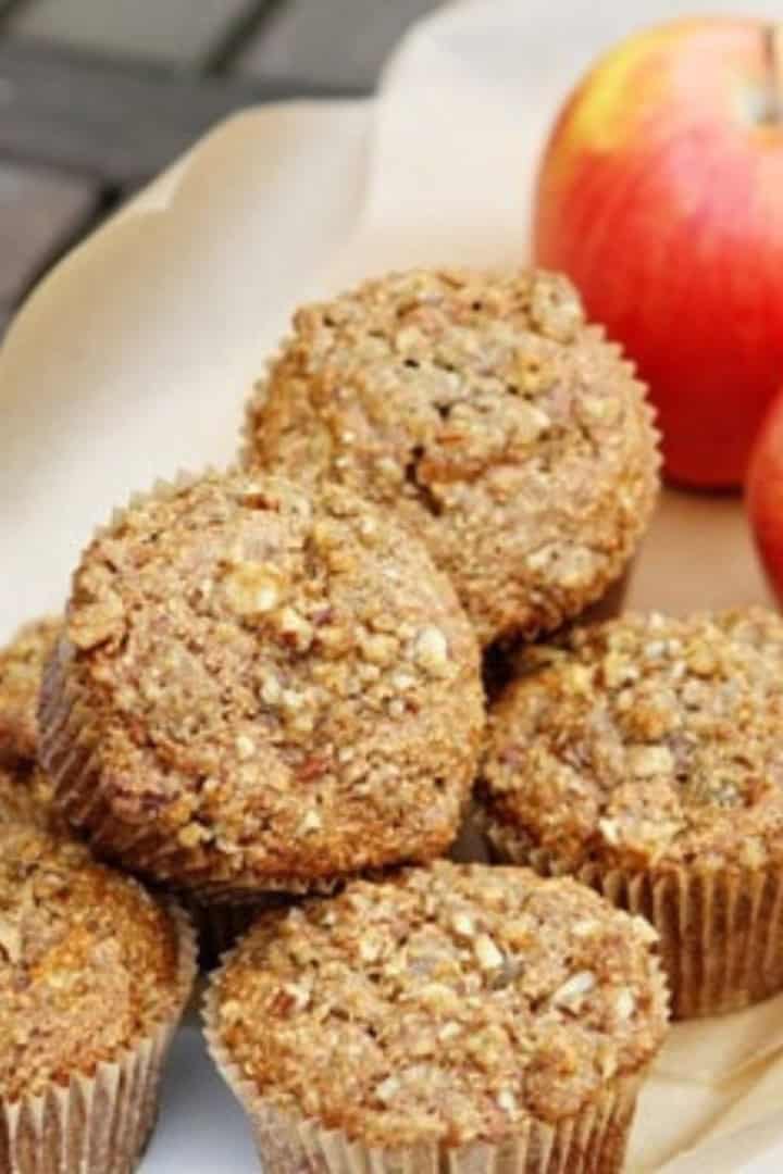 apple and bran muffins with pecan streusel topping on a white serving tray