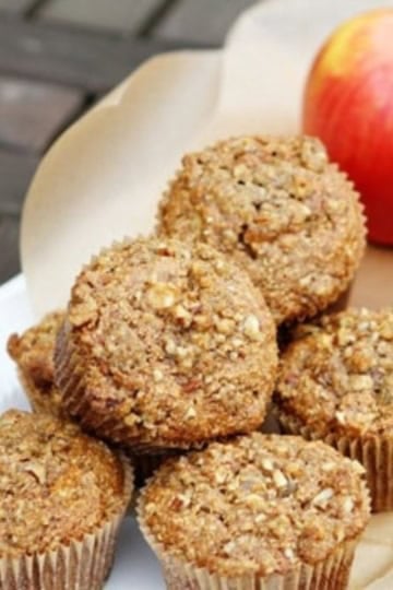 apple bran muffins with pecan streusel on a white ceramic serving tray