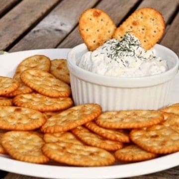 dill dip in a bowl with crackers around it