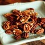 toasted pecans on an aqua blue ceramic plate