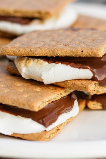 broiled indoor s'mores stacked on a white ceramic plate