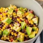 loaded guacamole salad in a grey ceramic bowl