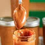 sweetened milk caramel in a glass canning jar with a spoon