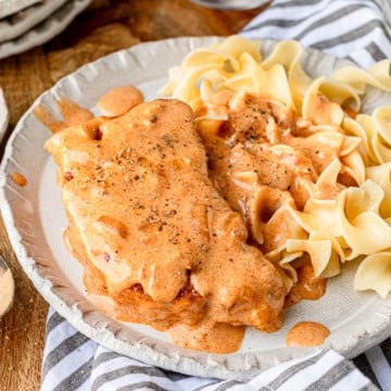 paprikash cast iron skillet pork chops recipe served over buttery egg noodles