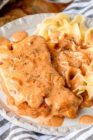 paprika sour cream pork chops recipe served over buttery egg noodles
